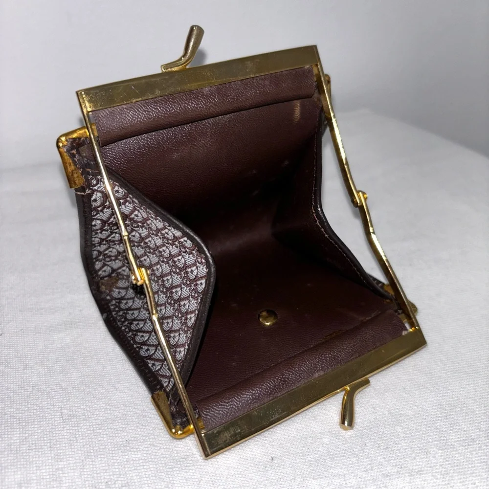Beautiful Dior coin pouch with golden kiss lock closure and golden logo on front